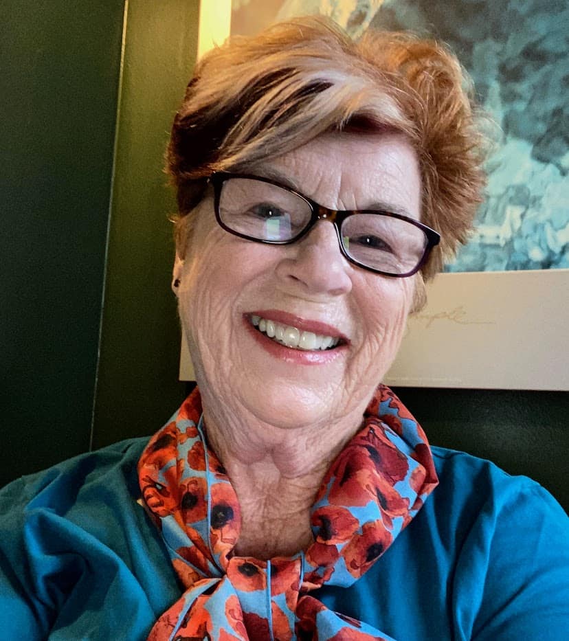 profile picture of a woman with glasses and short red hair